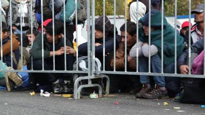 Migrants wait at Sentilj on the Slovenian Austrian border