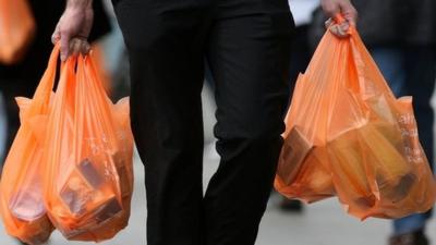 Shopper carrying plastic bags