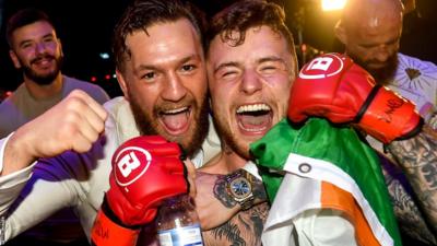 A victorious James Gallagher celebrates with his SBG team mate and UFC star Conor McGregor