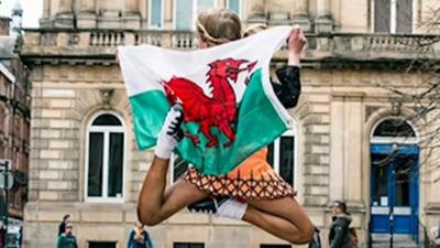 Ffion dancing in Glasgow with the Welsh flag