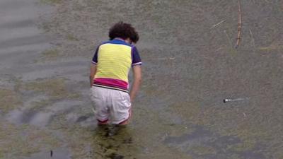 Golfer's mum fishes out her son's putter from pond