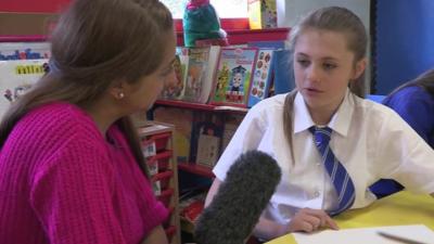 Naz talks to a pupil