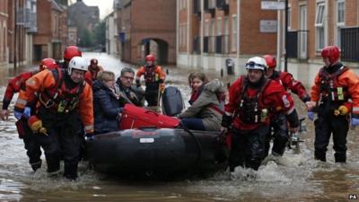 A family is rescued from the centre of York by boat during severe flooding