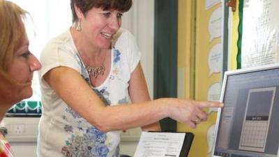 Woman teaching computer skills