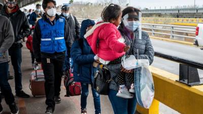 Asylum seekers enter Brownsville, Texas from Mexico