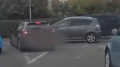 Car has a near-miss while being followed by a police car.