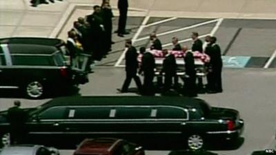 Coffin of Whitney Houston's daughter Bobbi Kristina Brown being carried towards a hearse after a funeral service in Georgia