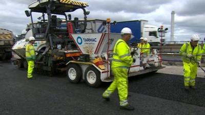 Workers repairing M5