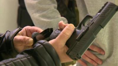 Man loading gas pistol