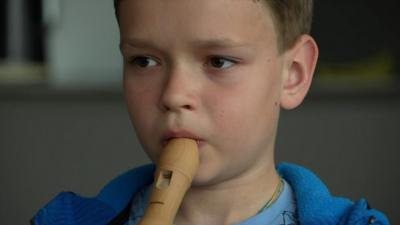 child playing recorder