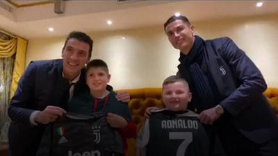 Gianluigi Buffon and Cristiano Ronaldo with two Albanian boys who survived last month's earthquake there