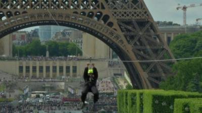 Man travelling on zip wire from Eiffel Tower