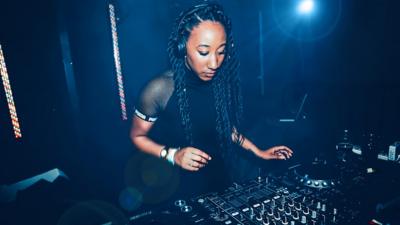 Jamz Supernova DJing in a club.