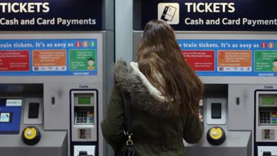 Person buying train ticket