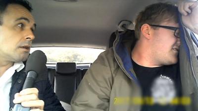 Jonathan Gibson (l), confronts man in car