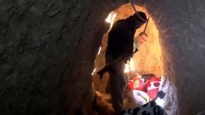 A man walks through an Islamic State tunnel