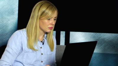 BBC Trending reporter looks at laptop