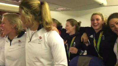 Some of Team GB singing the national anthem on the plane - still from footage filmed by Asha Philip