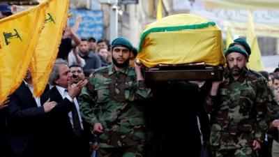 Hezbollah members carry the coffin of Mustafa Badreddine