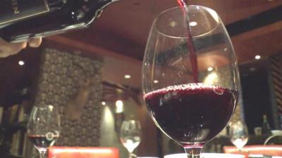 Wine being poured into a glass