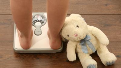 A child on a set of weighing scales