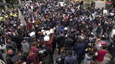 Couriers protest outside Uber Eats offices in London