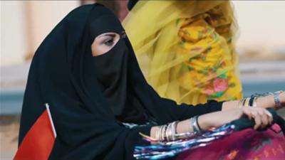 Saudi woman pushing trolley