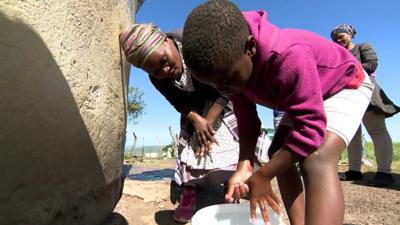 Young boy washing his hands