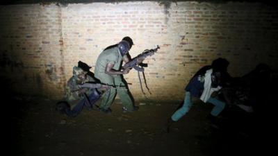 Armed vigilantes patrol in the centre of Bujumbura, Burundi.