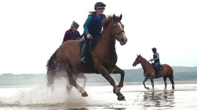 Rider on horseback on Morecambe Bay sands