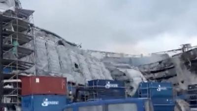 Building covered in scaffolding collapses