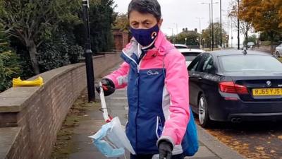 A woman picking up litter