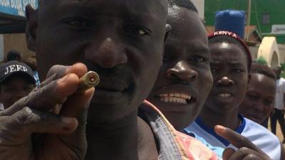 A man in Kisumu holding a bullet