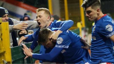 Linfield players celebrate scoring