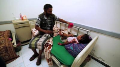 A girl and her father in a Sanaa hospital