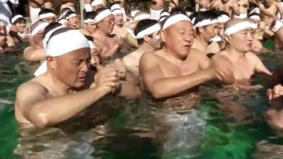 People taking an ice bath in Japan