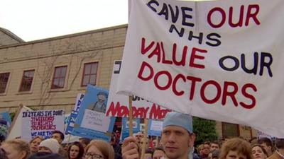 Protestor holds banner at march in Newcastle