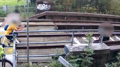 Couple taking photos on rail line