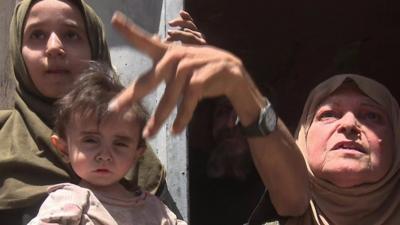 Mosul residents gesture as they speak to the camera - 1 July 2017