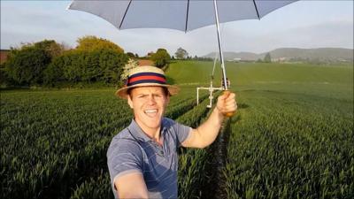 Many farmers are experiencing low yields because of the drought. One farmer keeps his spirits high by singing karaoke in his combine harvester.