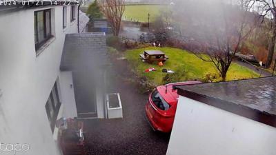 A tree falls on a black car in Lochwinnoch.