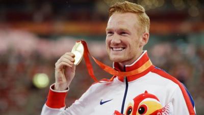 Long jump gold medallist Britain's Greg Rutherford holds up his medal during the medal ceremony at the World Athletics Championships at the Bird's Nest stadium in Beijing