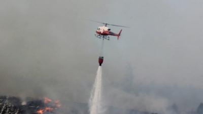 Helicopter hosing fire