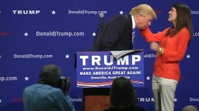 Donald Trump supporter examines his hair