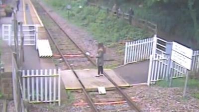 Girl taking a selfie on railway line