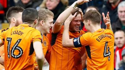 Wolves celebrate scoring against Liverpool at Anfield