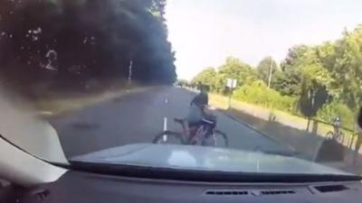 Young cyclist pedals across path of oncoming car