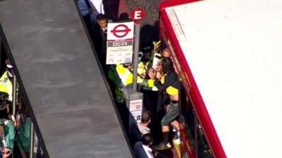 Person being dragged off bus by police