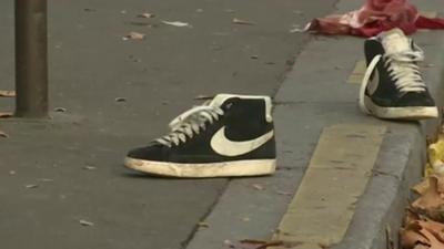 Trainers in street outside Bataclan concert hall