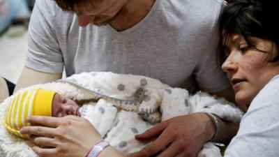 A new born baby with parents